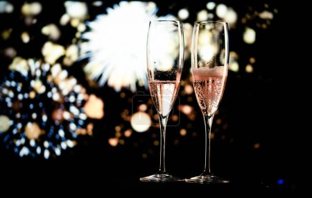 Photo for Two champagne glasses and festive light happy New Year - Royalty Free Image
