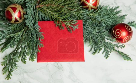 Photo for Red Christmas card on green fir branches - Royalty Free Image