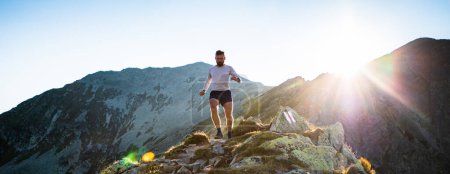 Photo for Trail runner running in mountain landscape at sunset active lifestyle - Royalty Free Image