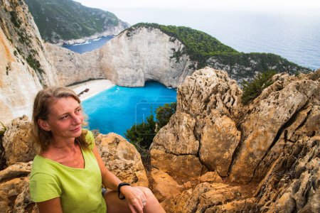 Téléchargez les photos : Femme regardant Navagio plage avec le célèbre navire naufragé à Zante Grèce - en image libre de droit