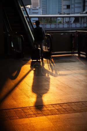 Photo for Commuter silhouette with suitcase in metro - Royalty Free Image