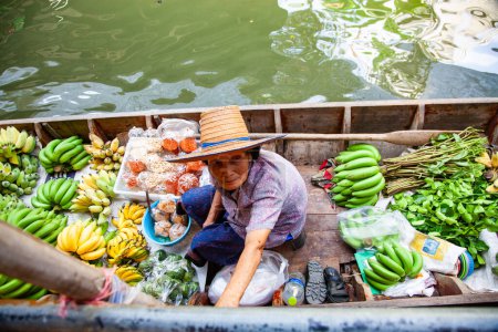 Photo for BANGKOK, THAILAND FEBRUARY 2019 vendors selling fresh produce on sale on floating market in Thainland - Royalty Free Image