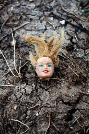 Photo for Doll head in the mud - Royalty Free Image