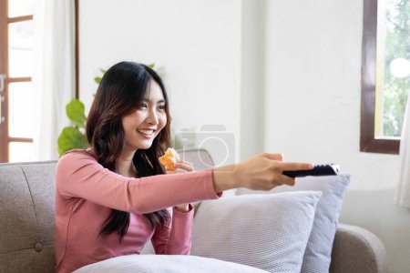 Photo for Beautiful asian businesswoman, entrepreneur, or freelance in casual clothes sitting at desk with paperworks and laptop casually working online in living room at home. At home, business concept. - Royalty Free Image