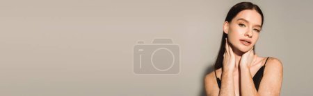 Photo for Pretty woman with vitiligo touching neck on grey background with shadow, banner - Royalty Free Image