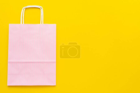 Photo for Top view of paper shopping bag on yellow background with copy space - Royalty Free Image