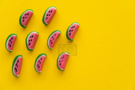 Photo for Top view of sweet candies in watermelon shape on yellow background - Royalty Free Image
