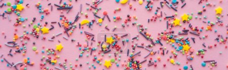 Photo for Top view of different sprinkles on pink background, banner - Royalty Free Image