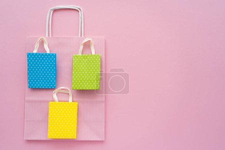 Photo for Top view of different shopping bags on pink background - Royalty Free Image