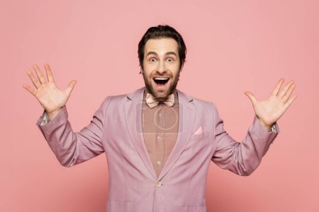 Photo for Excited host of event looking at camera on pink background - Royalty Free Image