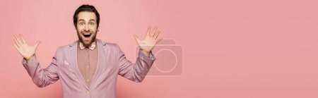 Photo for Excited host of event in jacket and bow tie looking at camera on pink background, banner - Royalty Free Image