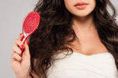 partial view of brunette woman with tangled hair holding red hair brush isolated on grey Longsleeve T-shirt #632784870