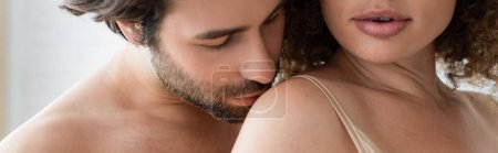 bearded and shirtless man kissing shoulder of sexy woman, banner 