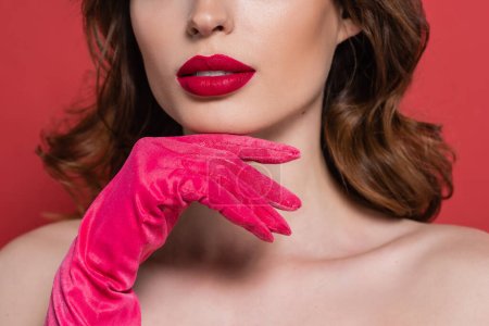Téléchargez les photos : Cropped view of young woman with magenta color glove isolated on pink - en image libre de droit