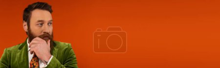 Photo for Bearded model in jacket looking away on red background, banner - Royalty Free Image