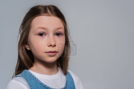 Photo for Patriotic girl looking at camera and crying during memorial day isolated on grey - Royalty Free Image