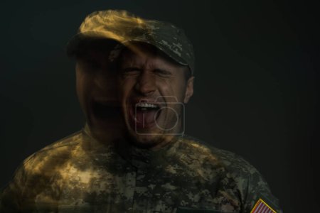 Doppelentblößung eines Soldaten in Uniform, der schreit, während er an ptsd leidet, isoliert auf dunkelgrau 