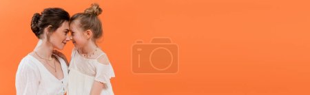summer trends, mother-daughter bonding, young woman and preteen girl posing on orange background, white sun dresses, togetherness, fashion and style concept, nose to nose, banner 