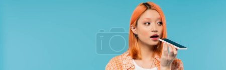 social media influencer, young asian woman with dyed hair holding smartphone and sending voice message on blue background, mobile phone, youth culture, digital age, generation z, banner