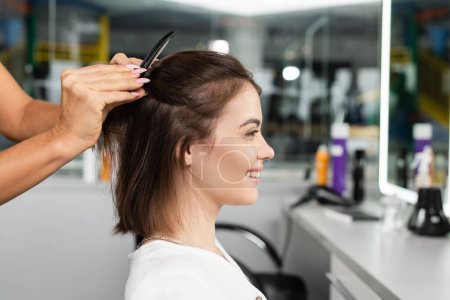 Photo for Salon job, beauty worker clipping hair of happy woman, professional hair clip, hairstyling, hair treatment, hairdo, extension, salon customer, beauty profession, client satisfaction, side view - Royalty Free Image