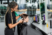 hairstylist spraying hair of female client, hairdresser with braids holding spray bottle near happy woman with short brunette hair in salon, hair cut, hair treatment, hair make over, hairdo  puzzle #660916710