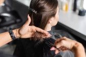 hair salon tools, cropped view of professional hairdresser cutting short brunette hair of woman, hair clip, beauty worker, haircut, beauty salon work, hairdo, scissors magic mug #660916862