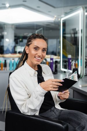 salon customer, woman with braids holding hair color palette in beauty salon, hair extension, hair coloring, salon client, hair trends, beauty industry, hair fashion, customer satisfaction  magic mug #660917292