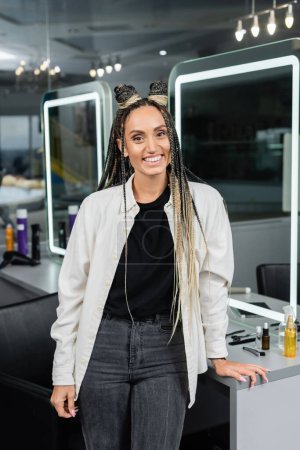 Photo for Salon, happy client with braids, cheerful woman with hair buns looking at camera, customer satisfaction, hair salon, hairstyle, female client, salon hair care, looking at camera, mirror - Royalty Free Image