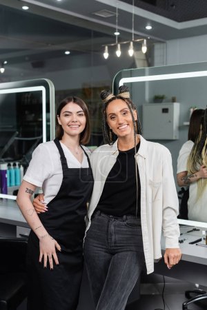 client satisfaction, hairdresser and happy woman with braids, hairstyle, hair buns, braided hair, beauty salon, hair fashion, salon customer and hairstylist hugging in salon 