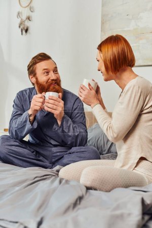morning rituals, quality time, coffee and conversation, day off without kids, redhead husband and wife, happiness, bearded man and woman holding cups, parents alone at home, lifestyle, adult leisure 