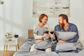 day off without kids, tattooed people, married couple holding glasses of red wine, redhead husband and wife, enjoying time, day off, weekends together, parents alone at home  Poster #661667654