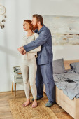 full length of married couple hugging in cozy bedroom, day off without kids, redhead husband and wife, enjoying time together, weekends together, tattooed, parents alone at home  Poster #661667728