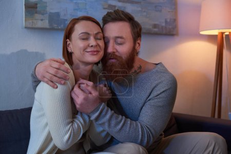 quality time, couple without kids, enjoying time, tattooed couple relaxing on weekends, husband and wife, bearded man hugging redhead woman, cozy living room, day off, home environment 