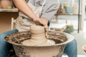 Cropped view of blurred female ceramicist in apron molding and shaping wet clay while working with spinning pottery wheel in art workshop, skilled pottery making concept Longsleeve T-shirt #663415804