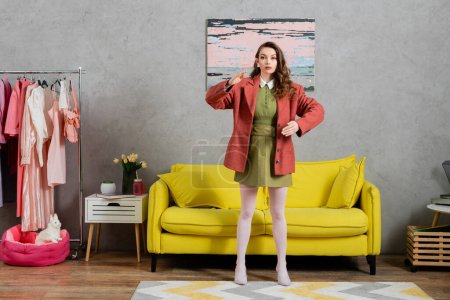 concept photography, full length of woman acting like a doll, gesturing unnaturally and standing near yellow couch, well dressed and beautiful, modern house interior, role play, doll life 