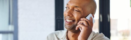 myasthenia gravis disease, bold african american man at work, cheerful and dark skinned office worker with ptosis syndrome talking on smartphone, inclusion, corporate culture, banner 
