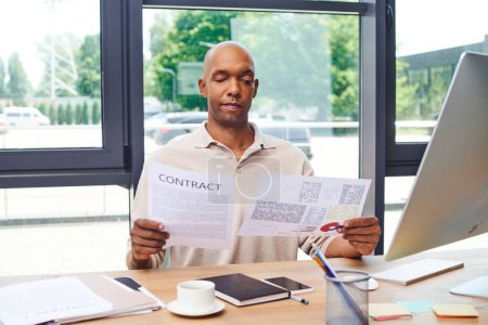 Photo for Inclusion, african american man with myasthenia gravis disease holding contract, dark skinned office worker in casual attire working at desk, smartphone, cup of coffee and stationery, monitor - Royalty Free Image