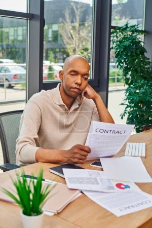 inclusion and diversity, african american man with myasthenia disease looking at contract, dark skinned office worker in casual attire sitting at desk, smartphone, documents and graphs 