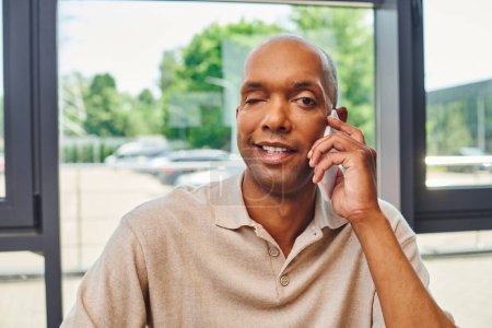 myasthenia disease, happy african american man at work, cheerful and dark skinned office worker with ptosis syndrome talking on smartphone, inclusion, corporate culture 