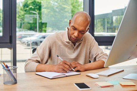 Photo for Inclusion, african american man with myasthenia gravis at work, bold and dark skinned office worker taking notes, corporate culture, monitor and smartphone, computer mouse and keyboard on desk - Royalty Free Image