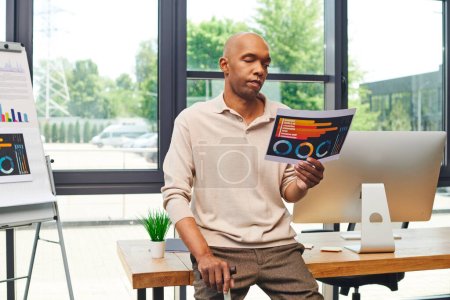 Photo for Inclusion, myasthenia gravis, bold african american businessman standing with walking cane and looking at charts near computer monitor, dark skinned office worker in casual attire - Royalty Free Image