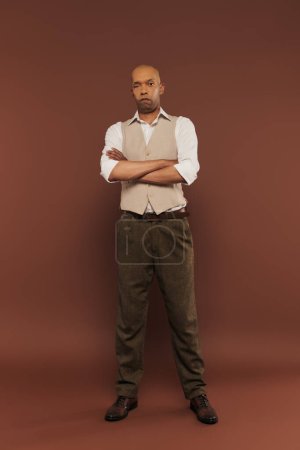 inclusion, myasthenia gravis syndrome, bold african american man standing with folded arms, looking at camera, dark skinned, real people, neurological disorder, physical impairment, full length 