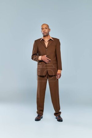 Photo for Chronic illness, bold african american man with myasthenia gravis standing on grey background, dark skinned person in formal wear, diversity and inclusion, real people, full length - Royalty Free Image