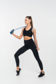 woman in fitness clothes holding jump rope and posing on white background, endurance  tote bag #664863076