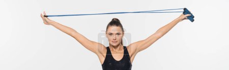 Fitte Sportlerin blickt in die Kamera, während sie das Springseil isoliert auf weiß hält, Banner, Sportkonzept