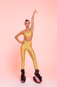 woman in sportswear and kangoo jumping shoes, pink background, toned body, motivation and energy  Mouse Pad 664865984