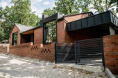 housing trends, brick contemporary house with metal gates and brick fence hoodie #664926272