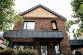 low angle view of contemporary city cottage, brick walls, large windows, property market magic mug #664926440