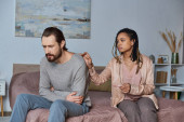 abortion concept, african american woman calming stressed man, bedroom, pregnancy test, unexpected hoodie #668922378