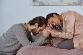 sad african american woman holding hands with man, worried multicultural couple bonding, empathy Poster #668922712